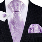 Purple paisley tie set with matching pocket square and cufflinks on a black suit.