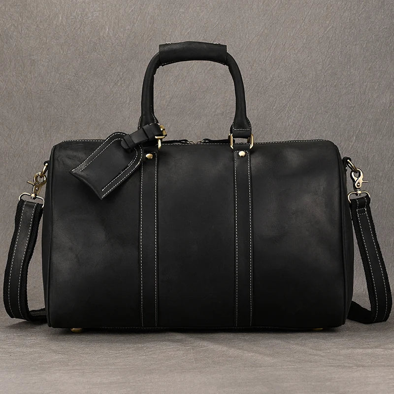 Black leather travel bag with adjustable shoulder strap for easy carrying